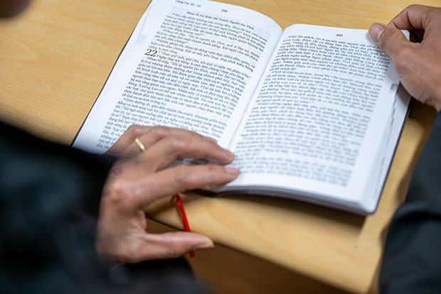 A woman's hands holding a Bible open