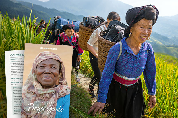 Women carrying supplies on their backs; cover of The Voice of the Martyrs' 2026 Global Prayer Guide