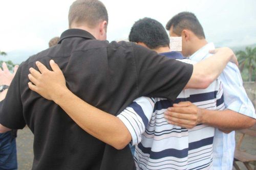 Praying-with-family-in-Colombia