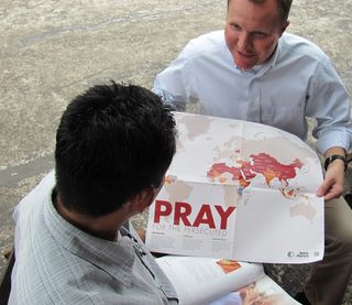 Showing prayer map to Pastor Eduardo