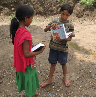 Showing book to Hindu neighbor boy after distribution